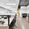 Modern office cubicle workstations with ergonomic chairs and wood accents in Vancouver